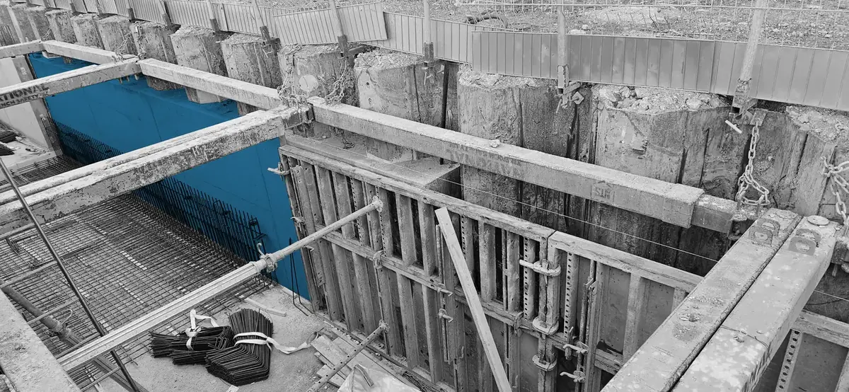 Basement excavation with piled retaining wall, capping beam and wall formwork ready for the reinforced concrete liner wall