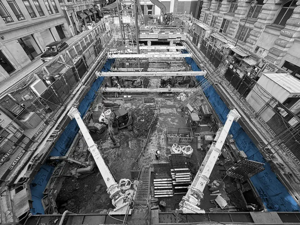 Deep basement construction between retained buildings on a central London site, seen from above